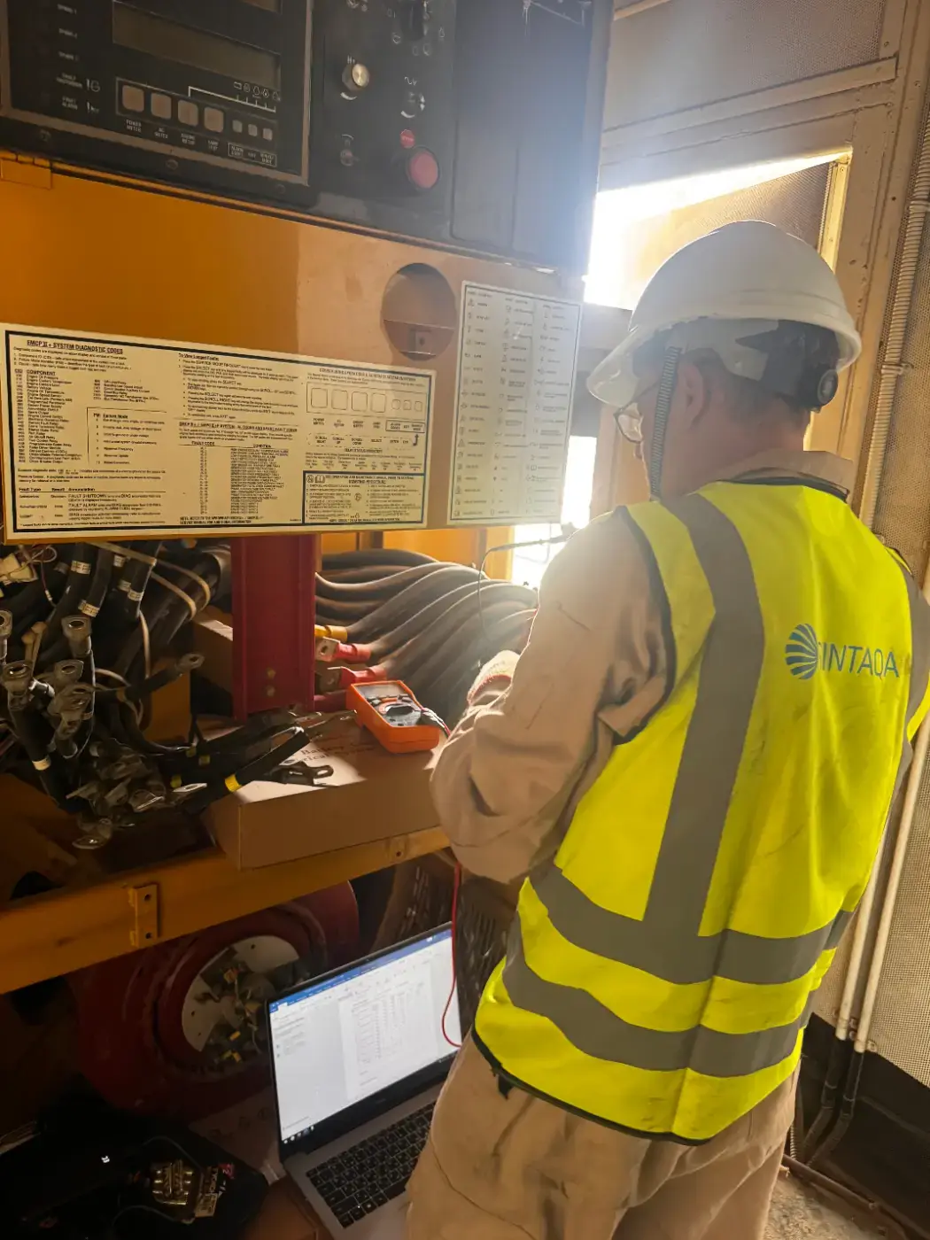 SINTAQA engineer checking a generator control panel