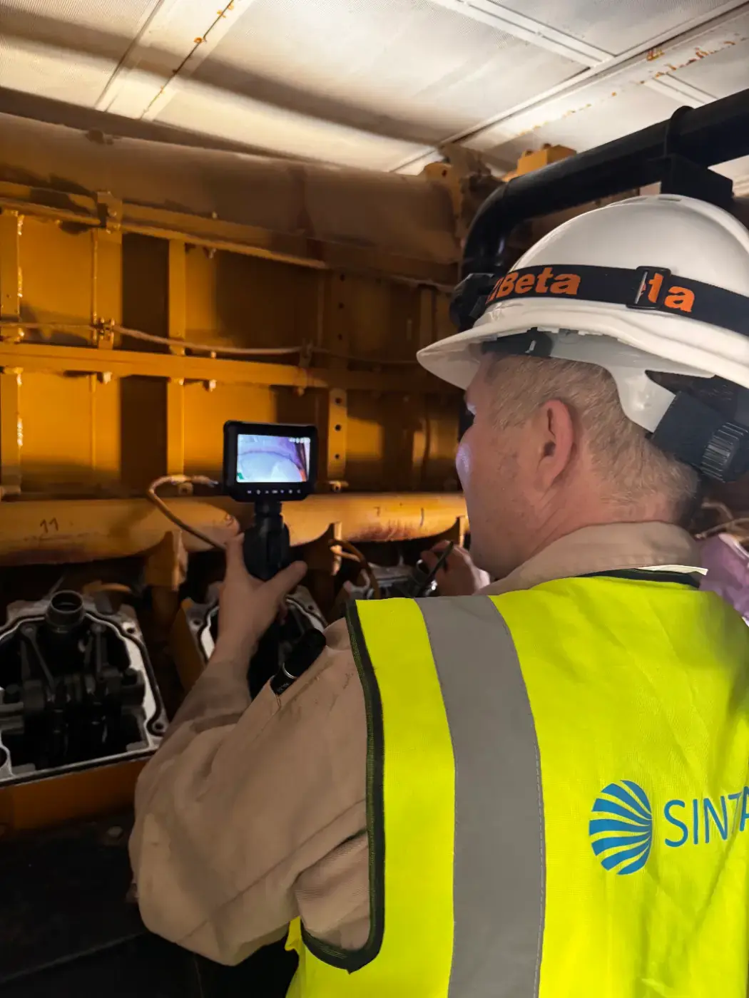 SINTAQA technician inspecting generator equipment